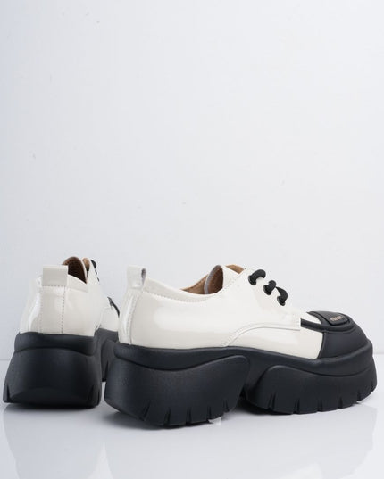 Zapatos blancos en charol con suela y cordones negros