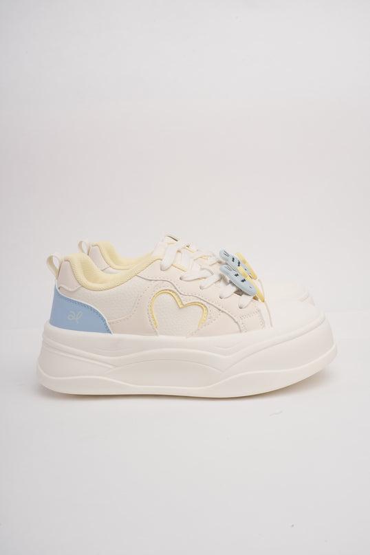 Tenis crema con detalles azul y amarillo